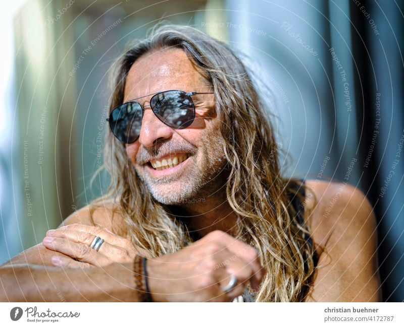 older hippie with sunglasses Man portrait 50 years Hippie Sun Summer Laughter long hairs Sunglasses fortunate Brilliant Model Happiness Alternative