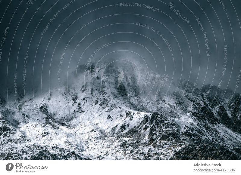 Rocky mountain ridge covered with snow rock range rough slope peak cloud panorama cold majestic scenery rocky nature landscape altitude environment picturesque