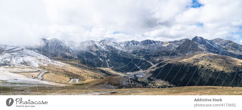 Rocky mountain ridge covered with snow rock range rough slope peak cloud panorama cold majestic scenery rocky nature landscape altitude environment picturesque