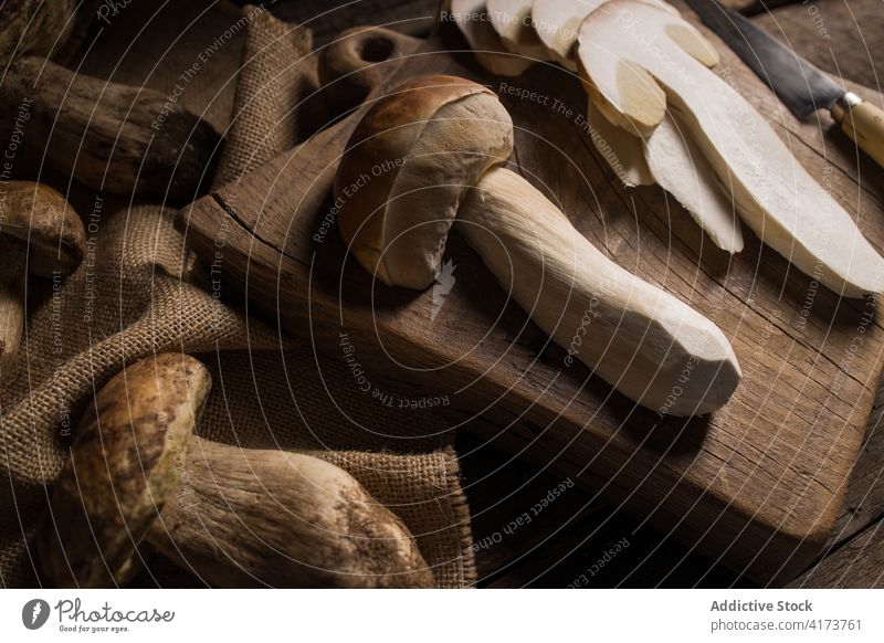 Sliced porcini mushrooms and knife on table boletus edulis cep slice cut fresh raw edible fungus organic food natural nutrition rustic ingredient vegan