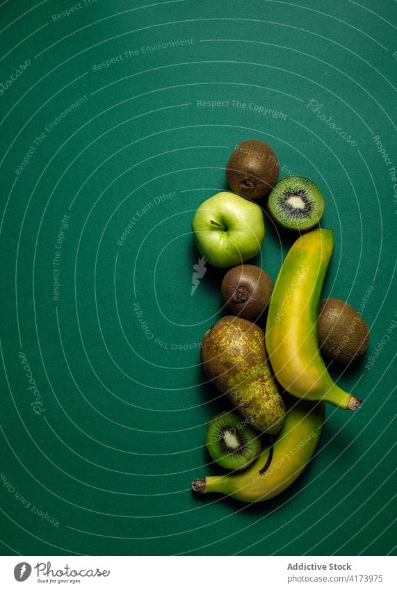 Various green fruits on table various fresh natural pear apple kiwi banana food healthy organic vitamin ripe color nutrition diet vegetarian tasty colorful