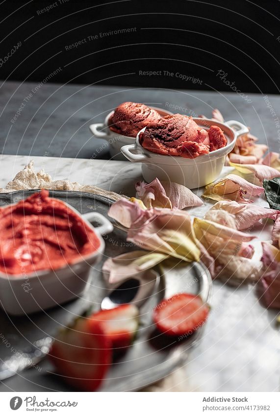 Yummy strawberry sorbet on table with rose flowers dessert pink sweet serve portion food color exquisite yummy gourmet delicious tasty cream mousse ice cream