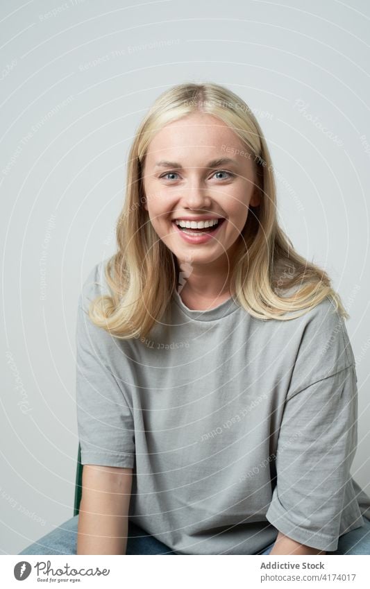 Delighted woman laughing in studio casual style natural beauty female cheerful positive delight glad happy young lady carefree content enjoy excited blonde