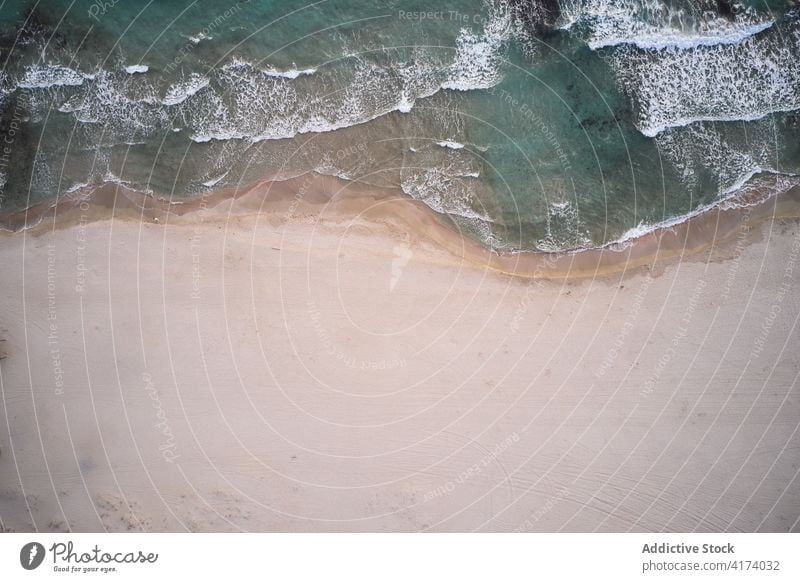 Sea waves washing sandy shore sea beach turquoise ocean water coast seaside nature foam travel seashore seascape coastline seaweed scenic tourism shoreline tide