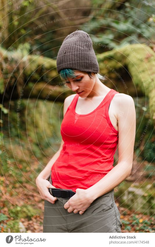 Woman standing in green forest traveler woman calm harmony recreation woods adventure summer explorer female holiday vacation serene tranquil tourism summertime