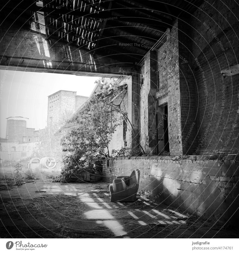 Cosy spot in an industrial ruin Armchair Industrial wasteland Ruin Transience Decline Building Warehouse Industrial plant Manmade structures Change