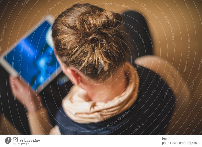 Young woman sits relaxed cross-legged and streams a music video Woman youthful feminine Music Listening streaming Lifestyle Colour photo Feminine Human being