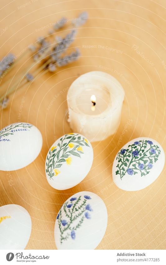 Various painted eggs arranged on table easter aquarelle flower holiday religious food tradition lavender candle spring religion decor color set collection