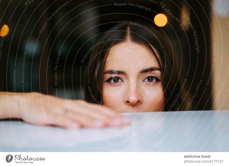 Calm young brunette looking at camera woman calm confident tranquil serene portrait human face appearance female relax millennial lady charming pleasant