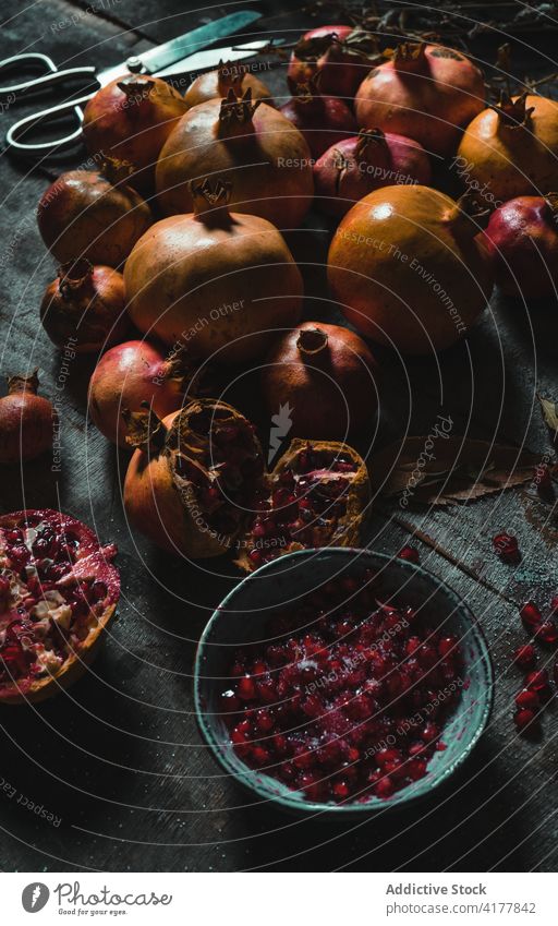 Ripe pomegranates on dark table fruit fresh natural delicious sweet color dried plant colorful pile composition heap nutrition season healthy food organic