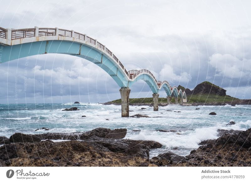 Bridge over sea on cloudy day bridge stormy scenery seascape construction gloomy seaside island east coast overcast weather water sky beach scenic old nature