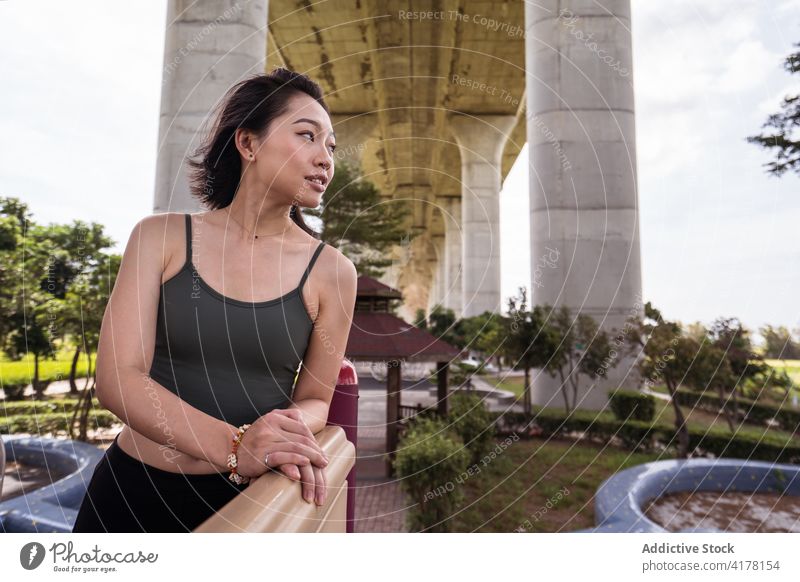 Asian woman relaxing in urban park in summer city weekend enjoy tranquil summertime female asian ethnic taichung taiwan rest calm dreamy peaceful content