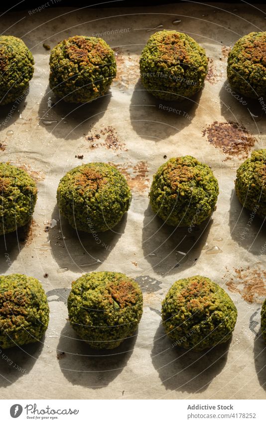 Green vegan falafel balls on baking paper green baked edamame bean pea vegetarian food tradition mediterranean arabian middle east crispy meal delicious cook