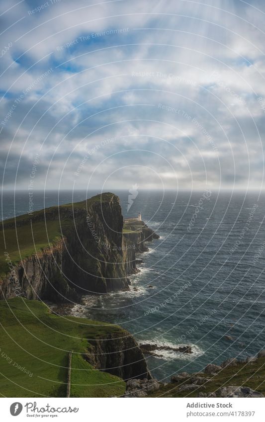 Scenic rocky cliff with lighthouse near sea neist point lighthouse beacon landscape seascape amazing isle of skye scotland united kingdom uk green scenic water