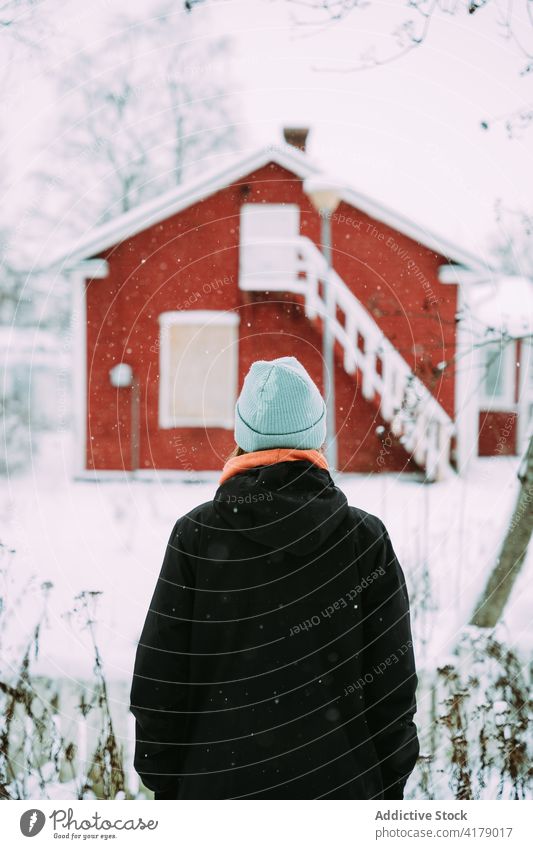 Anonymous woman in warm clothes enjoying winter tranquil nature wintertime cold snow white female outerwear village serene peaceful countryside calm harmony