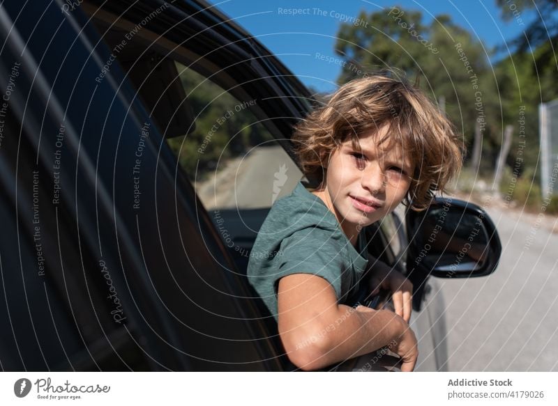 Kid looking out of car window in nature kid mountain adventure summer boy travel trip enjoy male preteen automobile child journey vacation holiday vehicle