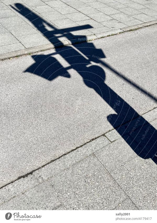 The traffic lights cast their shadow in the sunlight ahead Traffic light Traffic lights Shadow Traffic lane Sidewalk Cycle path Transport Road traffic Asphalt