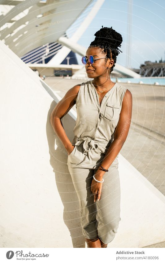 Happy black woman standing on street female ethnic african american cool sunglasses happy style smile urban young optimist trendy glad positive expressive