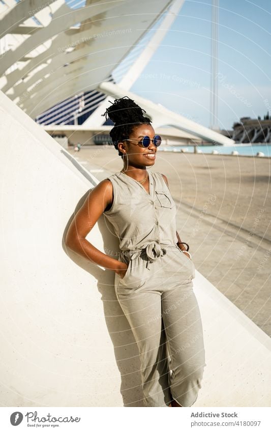 Happy black woman standing on street female ethnic african american cool sunglasses happy style smile urban young optimist trendy glad positive expressive