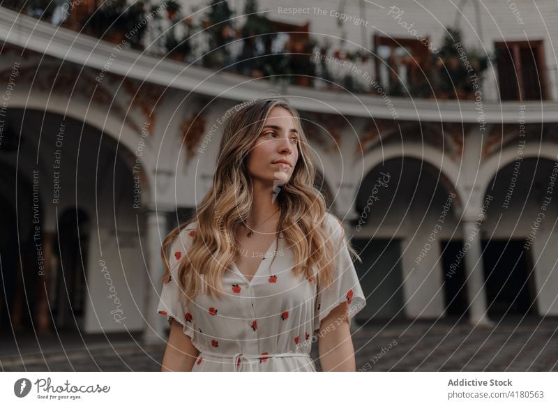 Dreamy traveler against old building in town vacation trip dreamy gentle lifestyle architecture ornament woman city contemplate ponder idyllic wistful pavement