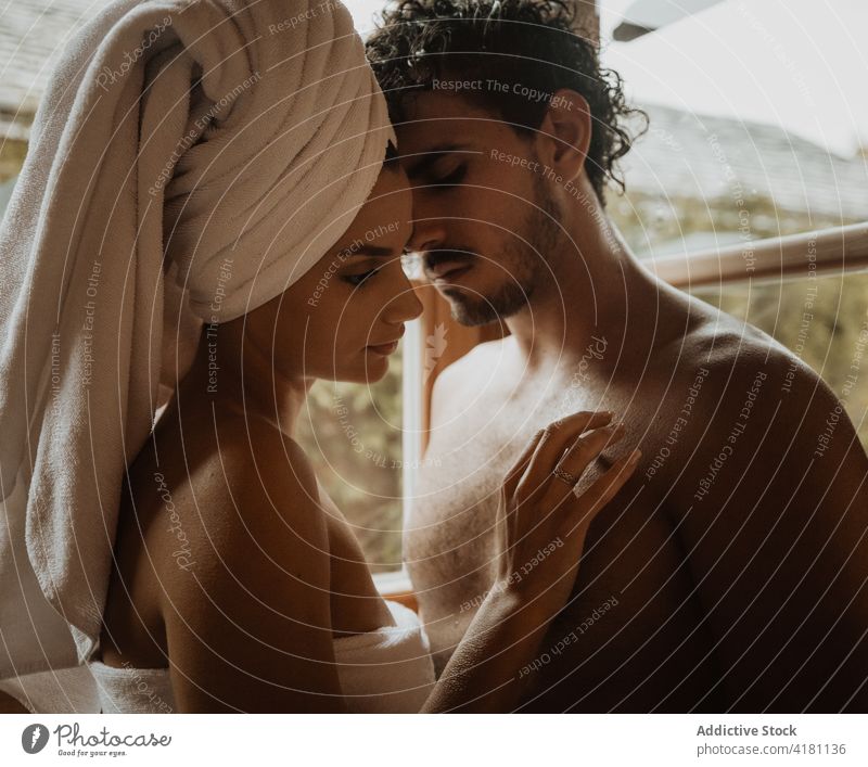 Mindful couple embracing in cabin on rainy day embrace love relationship eyes closed fondness honeymoon towel wrap pleasure idyllic shack enjoy amorous gentle