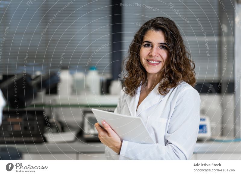 Woman in white coat working in laboratory scientist woman research pharmaceutical medical chemist professional female scientific job occupation workplace