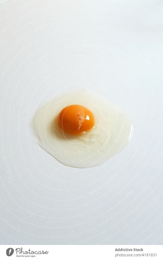 Raw egg on white background raw healthy food fresh yolk organic product uncooked natural studio minimal ingredient chicken hen bright nourish nutrition nutrient