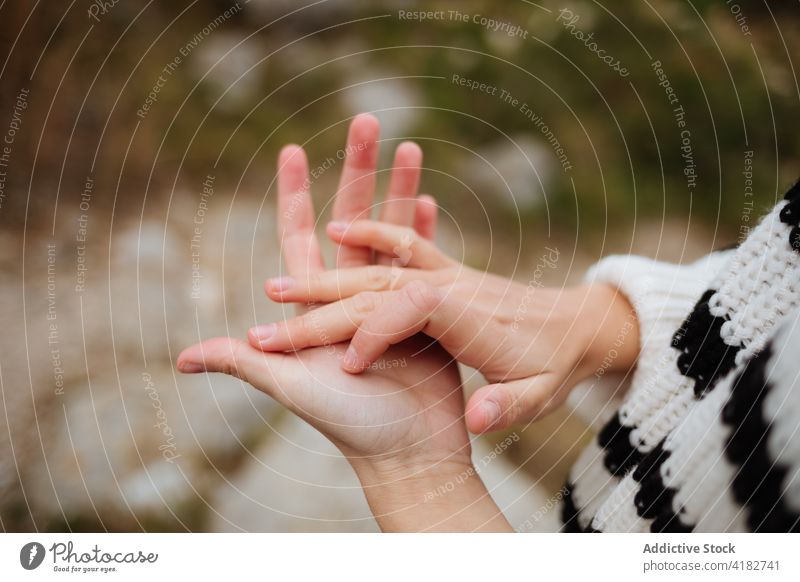 Faceless traveler with clasped hands on mount hands clasped friendship gentle tender gesture trip vacation mountain woman sweater knitted nature show ornament