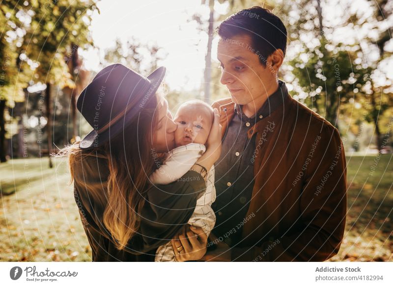 Happy family with baby resting in park together love happy parent relationship bonding care infant child mother father kid parenthood childhood mom enjoy