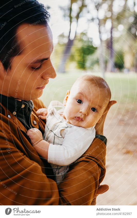 Father with baby resting in park dad love together infant child kid father relationship bonding parenthood adorable childhood babyhood fondness enjoy fatherhood