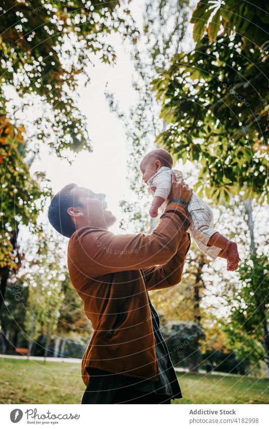 Father with baby resting in park dad love together infant child kid father relationship bonding parenthood adorable childhood babyhood fondness enjoy fatherhood