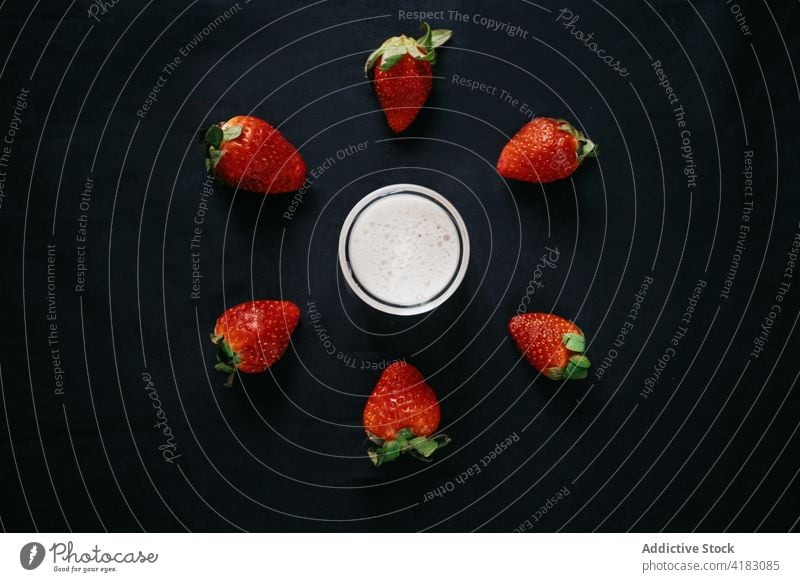 Jar of milk near ripe strawberries on black background jar strawberry dairy vitamin protein natural ingredient sweet smoothie glass transparent nutrient