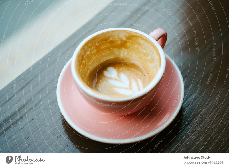 Closeup of a cup of coffee with milk seen from above isolated capuccino breakfast drink cafe white cappuccino hot latte beverage brown background aroma art