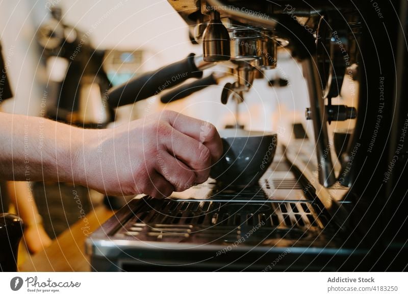 Crop barista preparing hot coffee in cafe coffeemaker prepare coffee shop machine cup drink man modern male professional beverage work staff service job