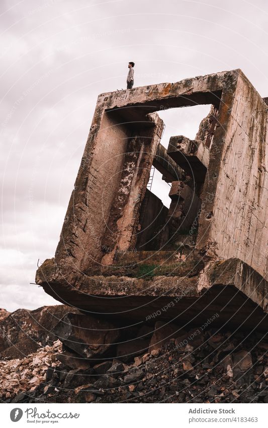 Abandoned quarry with damaged construction under white sky abandoned destroy desolate stone messy weathered cloudy rough open pit cement piece concrete material