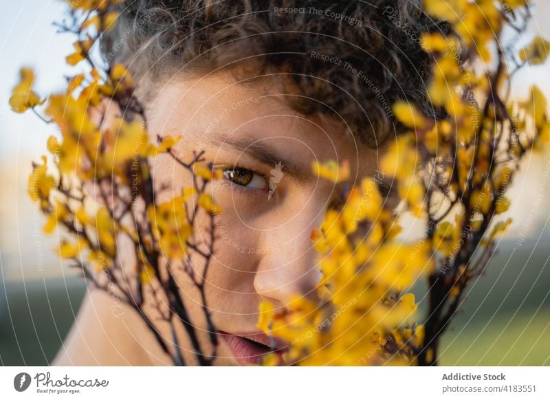 Crop man with blooming flowers in summer cover face bouquet botany scent natural portrait gentle petal idyllic bright flora aroma tender floral fresh organic