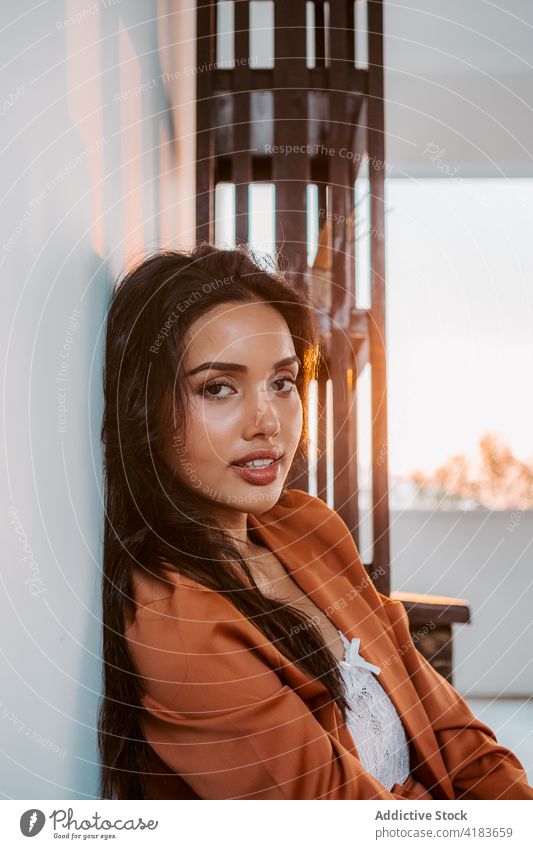 Relaxed stylish woman sitting on floor relax sensual style rest enjoy dreamy peaceful tranquil serene young ethnic female feminine calm barefoot beautiful