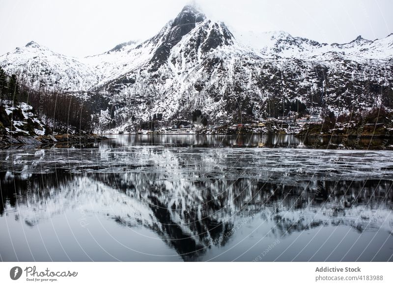 Winter seascape and mountains under cloudy sky winter highland scenery cold magnificent rock norway nature breathtaking amazing peaceful landscape majestic gray