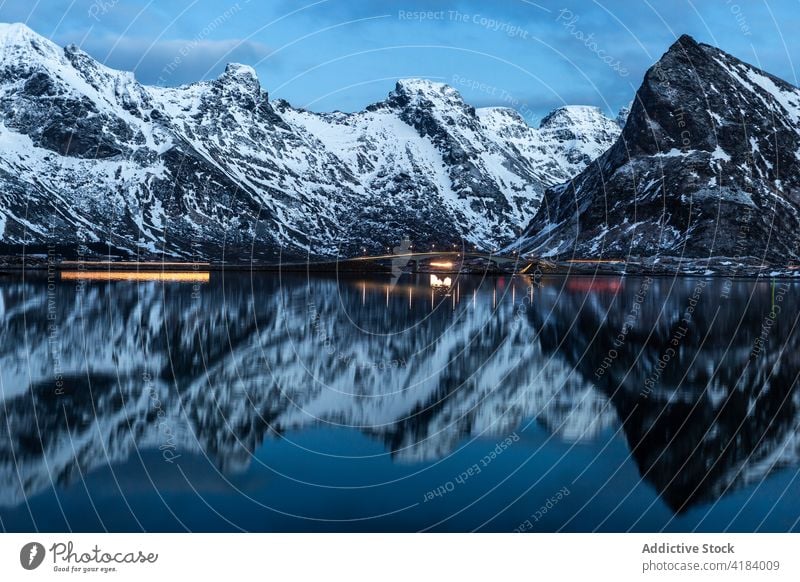 Piers with glowing lights near sea in winter pier mountain harbor bay illuminate evening dark norway terrain water twilight dusk peaceful smooth reflection