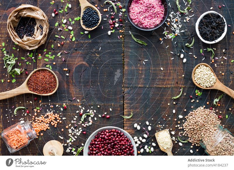 Spilled cereal in frame on wooden table background rustic organic grain abundance natural layout ingredient raw seed circle spoon spill food arrangement