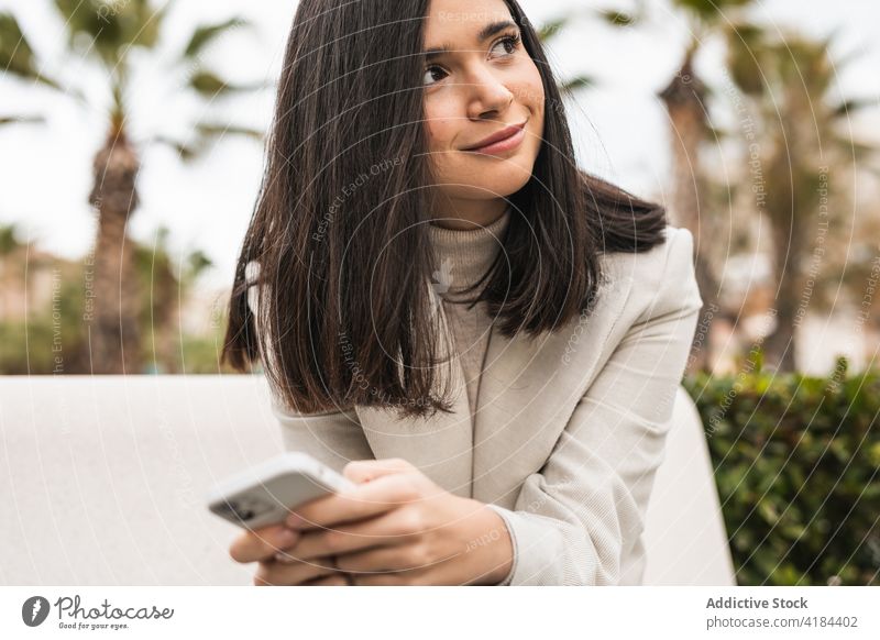 Businesswoman browsing smartphone in city street businesswoman check email message using entrepreneur female internet mobile device gadget cellphone sms