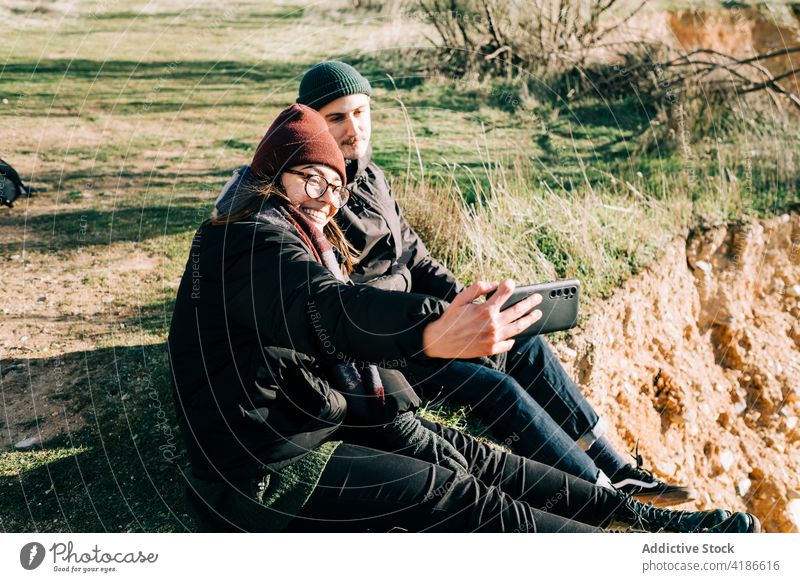 Couple travelers taking selfie on smartphone on ridge tourist happy mountain gorge moment couple memory friend using smile gadget device winter woman friendship