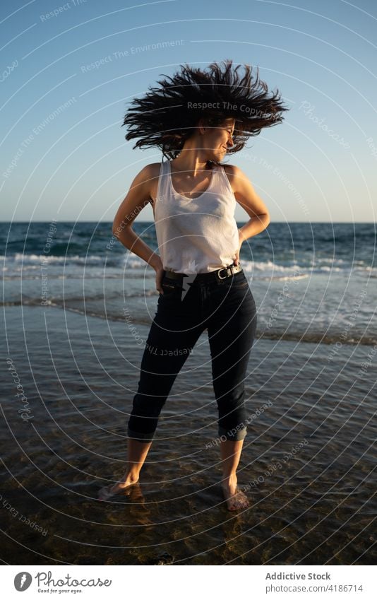 Woman standing in the sea shore on a summer day female woman nature beautiful stone beauty lifestyle happy fashion outdoor beach young sunset hair freedom