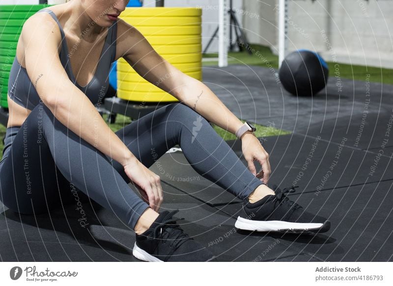 Sporty woman resting after training in gym sportswoman workout functional exercise active fit muscular female athlete healthy fitness activity physical wellness