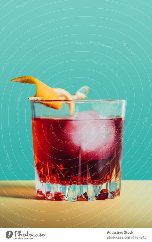 Glass of refreshing classic Negroni cocktail on light surface negroni alcohol bitter orange refreshment blend cold citrus delicious mix drink booze beverage gin