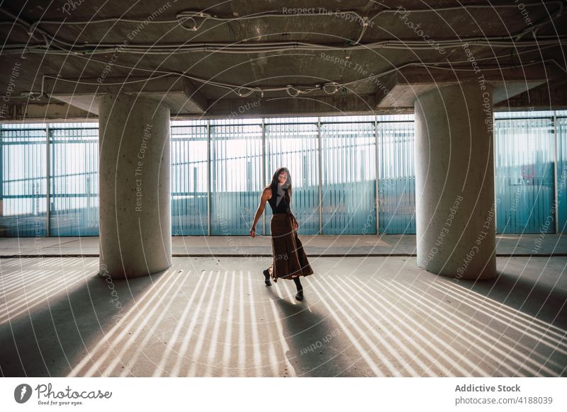 Dancer dancing in building during rehearsal artist dance choreography perform shadow theater woman prepare practice shade glass wall dancer flexible profession