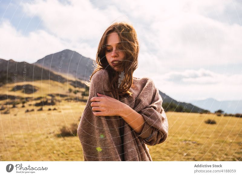 Tourist touching arm against ridge under cloudy sky traveler touch arm gentle vacation tourism nature woman tender romantic tourist mountain trip casual outfit