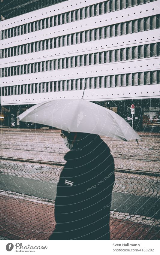 Stroller in the rain with umbrella Architecture Rain Umbrella Snow Storm street Weather Wet rainy Autumn seasonal Outdoors rains Water City outside