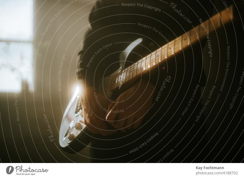 man playing an electric guitar on stage adult arm artist chords closeup dark expertise fingers fretboard guitar player guitarist guitarists guitars hands hobby