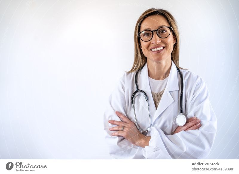 Female doctor in white uniform standing in hospital medic woman smile clinic female professional job specialist staff medicine health care corridor positive